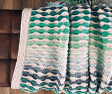The Beckett Textured Crochet Blanket Pattern with Self-Striping Yarn